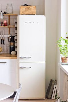 a white refrigerator freezer sitting inside of a kitchen