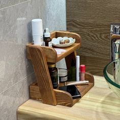 a wooden shelf holding cosmetics and other items