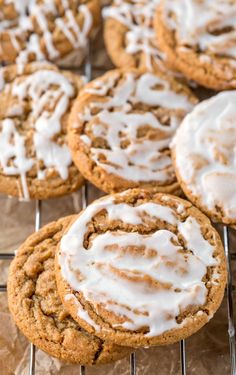 several cookies with icing on a cooling rack