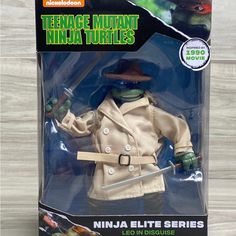 the teenage mutant ninja turtles action figure is in its box and has a hat on