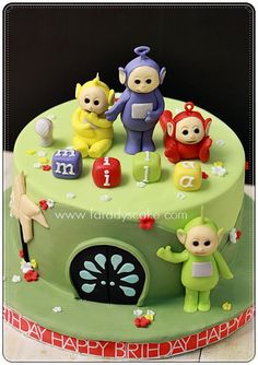 a green birthday cake with three little monkeys on top