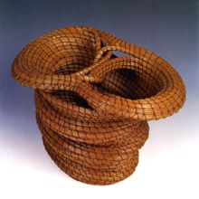 there is a woven basket in the shape of a vase