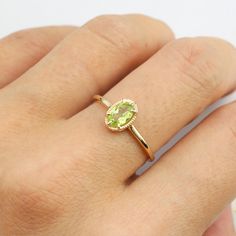 14k solid gold ring featuring ethically sourced genuine peridot size 6x4mm. Peridot is the birthstone for the month of August. Will make a great birthday gift and also a unique engagement ring for women who want something bit different from the ordinary diamond engagement ring. This antique-inspired ring has leaf gallery design on setting allowing more lights to go through the stone to maximize the brilliance of the stone. The band is tapered to give a delicate look yet being sturdy. * Peridot s Dainty Green Oval Birthstone Ring, Gold Oval Peridot Birthstone Ring, Oval Yellow Gold Peridot Rings, Yellow Gold Peridot Birthstone Ring, Green Peridot Birthstone Ring, Dainty Style, Oval Peridot Ring In Yellow Gold, Oval Peridot Birthstone Ring, Oval Yellow Gold May Birthstone Ring, Oval Peridot Birthstone Ring For May