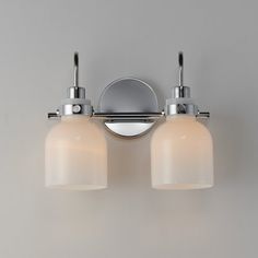 two light bathroom fixture in chrome finish with frosted glass shades on the bottom and sides