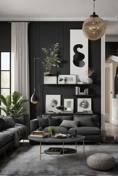 a living room with black walls and grey furniture in the center, along with pictures on the wall