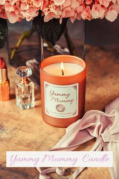 the image shows a candle on a table and under roses Pictures Of Candles, Mummy Candles, Receive Love, Sandalwood Fragrance, Floral Scents, Yummy Mummy, Cozy Candles, Bracelets With Meaning, Photo Candles