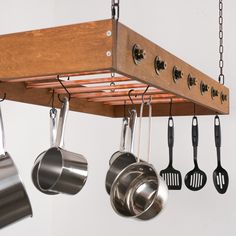 pots and pans hanging from a wooden rack