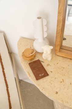 a small table with a mirror and some items on it