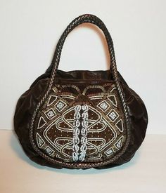 RARE ART DECO ANNA HANDBAG EMBELLISHED HAND BAG  THIS IS A BEAUTIFUL BAG THE BEAD WORK ON IT IS EXQUISITE.NWT$695. THIS BAG HAS ALL KINDS OF DIFFERENT SIZED SHAPED AND COLORED BEADS AND STUDDS ON IT.ITS FABULOUS THE BACK IS A BROWN LEATGER WITH A BIG BACK POCKET.THE HANDLE TRIM IS A METALIC LEATHER WEAVE AND TRIMS THE FRONT BART DECO BEADED  DESIGN PLEASE ZOOM INTO THE BEAD WORK IT IS TRULY STUNNING. "EXTRAMLY COOL".THE BAG IS MADE IF A DEEP DARK CHOCOLATE BROWN LEATHER. LUXURIOUS SILKY GOLDEN L Luxury Semi-formal Leather Shoes, Designer Embroidered Top Handle Bag, Designer Embroidered Tote Bag, Embellished Leather Rectangular Shoulder Bag, Luxury Handheld Beaded Shoulder Bag, Brown Hobo Bag With Handles For Evening, Brown Hobo Bag For Evening, Designer Embroidered Bags For Shopping, Formal Embroidered Top Handle Shoulder Bag