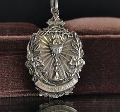 "A magnificent antique Catholic Communion medal, Art Nouveau period French religious holy medal, hallmarked, blank on reverse, in good used condition. A fairly rare religious holy medal, nice size, ideal for protection necklace, would make a nice gift for someone special! Floats from a 22 inch long 925 silver chain! Material: solid silver, hallmarked total weight: 10.5g Measures: approx 26 x 37 mm (1 x 1.5\" inch) A stunning religious shop well worth a visit ... https://etsy.me/2HAqjdY" Engraved Coin-shaped Spiritual Jewelry And Charms, Engraved Spiritual Medallion Jewelry, Engraved Round Pendant For Commemoration, Miraculous Medal Medallion For Commemoration, Catholic Communion, Protection Necklace, Lucky Charms, Amulets, Lucky Charm