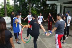 a group of people standing around each other with hula hoops