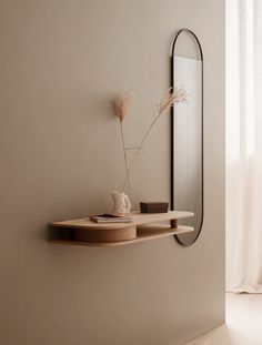 a mirror and shelf in a white room