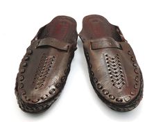 Check out our brand-new, genuine handcrafted Kolhapuri sliding sandals from India, high-quality leather sandals that are incredibly comfortable and simple to use. The leather is prepared in such a way that it has no allergenic characteristics at all and feels light, smooth, and silky. Hand stitching and punching are being used. These unisex slippers are ideal for everyday use as well as for any formal event. We offer various different shoe styles. For more of our selection, visit our page! We send packages to you promptly and well packaged for a safe journey. We appreciate your support of our little business. Shipped from the USA. Traditional Brown Mules With Rubber Sole, Traditional Brown Mules With Leather Sole, Leather Clogs With Round Toe For Vacation, Leather Slide Clogs For Beach, Leather Slide Clogs For The Beach, Vacation Slip-on Mules With Leather Lining, Slip-on Mules With Leather Lining For Vacation, Brown Leather Slippers For Vacation, Leather Lined Slip-on Mules For Vacation