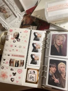 an open planner book with pictures and stickers on it's cover, sitting on a table