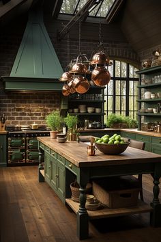 a large kitchen with green cabinets and wooden counter tops, hanging copper pots over the island