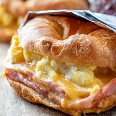 a bagel sandwich with ham and cheese on it