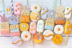 decorated cookies and marshmallows are arranged in the shape of peace, love, and flowers