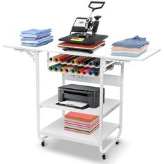 a computer desk with a printer, scanner and other office supplies on top of it