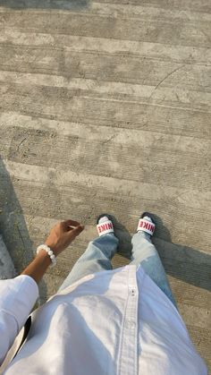 a person sitting on the ground using their cell phone