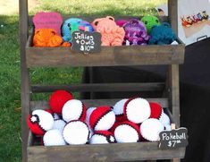 there are many crocheted items on display at this outdoor vendor's booth