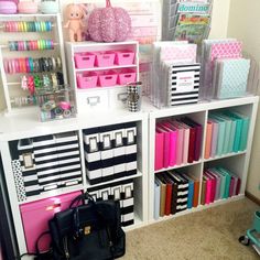 a room filled with lots of crafting supplies and storage bins on top of shelves