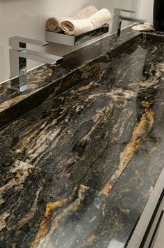 a bathroom counter with black and gold marble