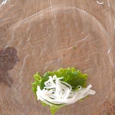 lettuce and shredded cheese on a clear plastic plate