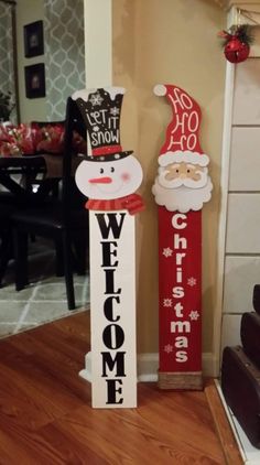 two wooden welcome signs sitting on top of a hard wood floor