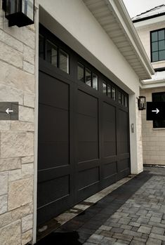 a black garage door on the side of a house