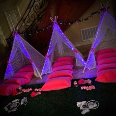 some pink pillows and lights on the ground