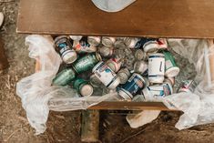 a wooden table topped with lots of cans