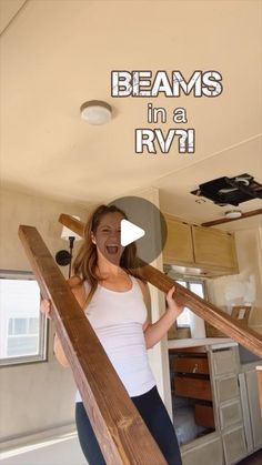 a woman standing on top of a wooden stair case with the words beams in a rv above her