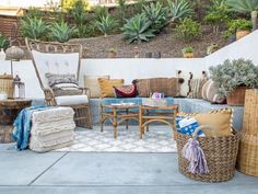 an outdoor patio with wicker furniture and potted plants