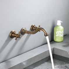 a faucet with water running from it and soap dispenser