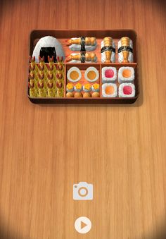 a wooden table with sushi and chopsticks in it on the phone screen