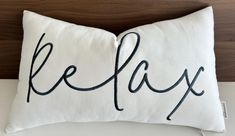 a pillow with the word relax written on it