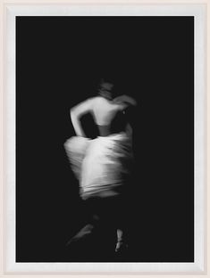 a black and white photo of a woman in motion with her hands behind her back