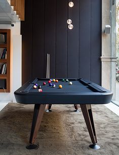 a pool table in the middle of a living room