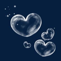 soap bubbles in the shape of hearts floating on a dark blue background