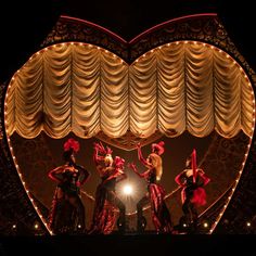 the dancers are performing on stage in front of a heart