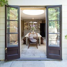 an open door leading to a dining room with a table and chairs in the doorway