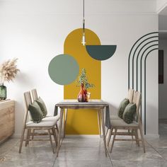 a dining room table with two chairs and a vase on the table next to it