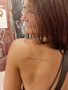 the back of a woman's shoulder with writing on it that says imagine air