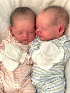 two babies are sleeping next to each other