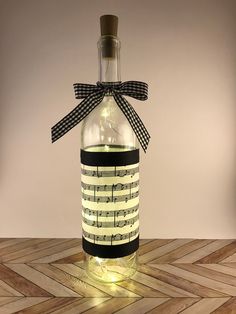 a bottle with musical notes on it sitting on a table