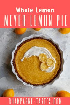 a pie with lemons and whipped cream in the middle, on top of a table