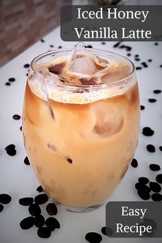 iced honey vanilla latte in a glass on a table with black and white dots