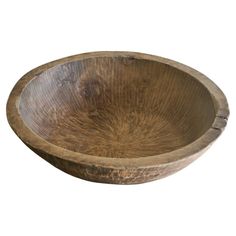 an old wooden bowl is shown on a white background