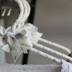 a close up of a white ribbon with blue flowers on it