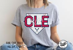 a woman sitting on the floor wearing a t - shirt that says cle with a baseball bat in it